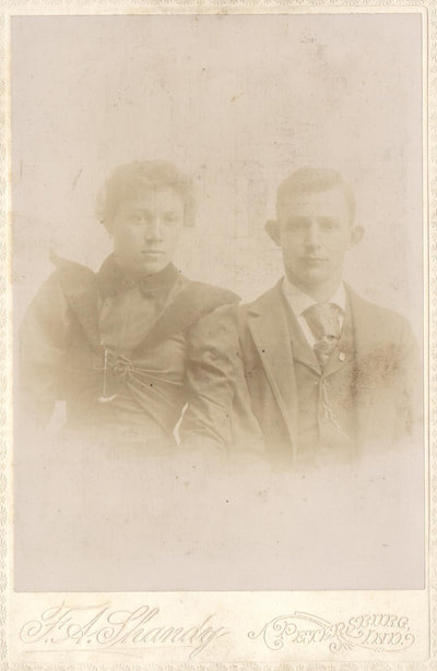 Woman and man in dress clothes seated together
