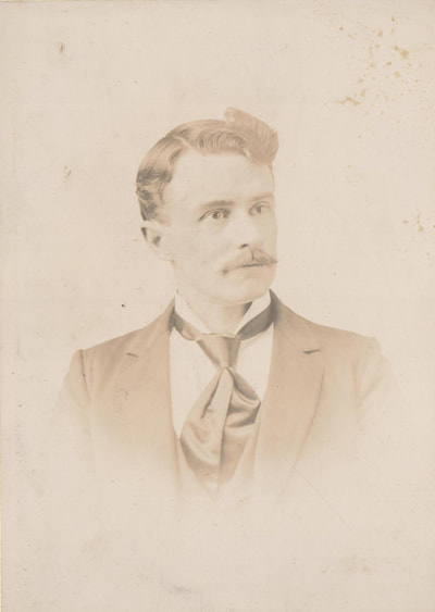 Man with mustache in suit and tie