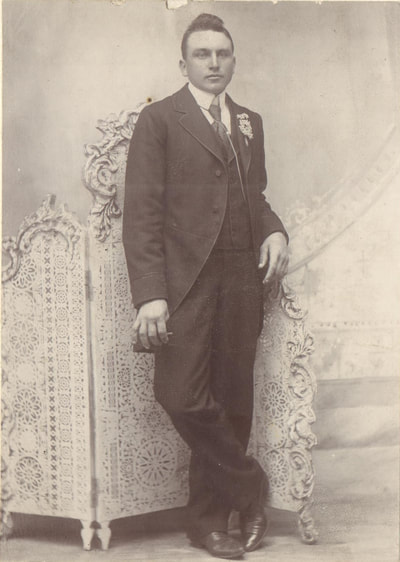 Young man in suit and tie standing 