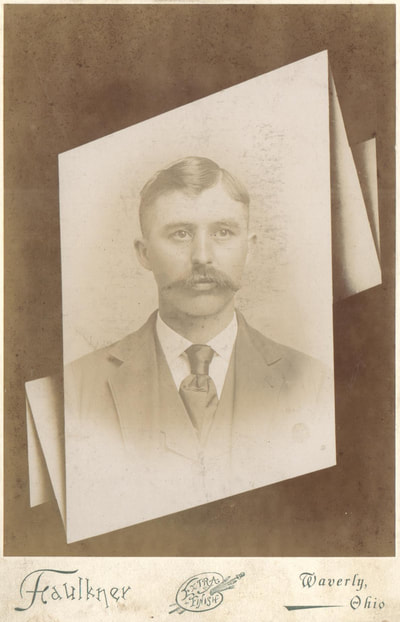Man with mustache in suit and tie