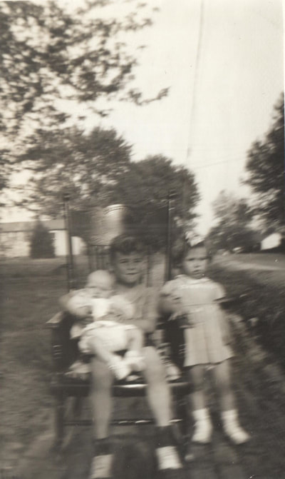 Pike County, Indiana, Judd Family, Boy holding Child in Rocking Chair Next to Standing Girl, Jimmy, Brenda, and Betty Ann Judd 
