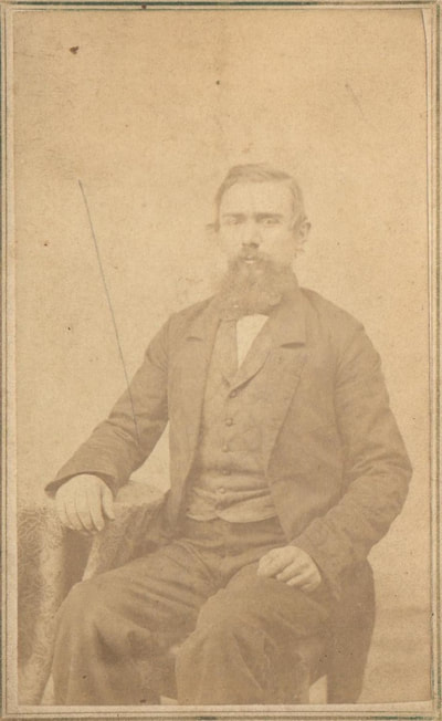 Man with beard seated in chair