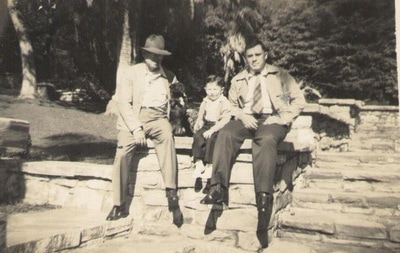 Men and Young Boy Seated on Stones