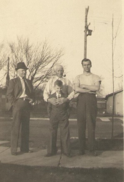 Men Standing on Sidewalk with Boy