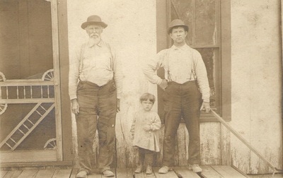 Men standing on porch next to young girl