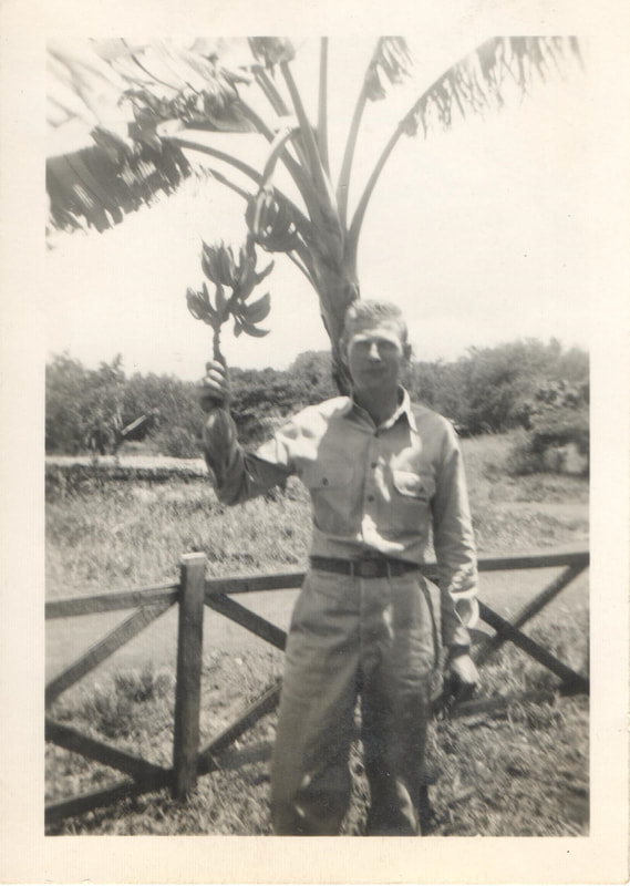 United States Army soldier holding banana tree stalk