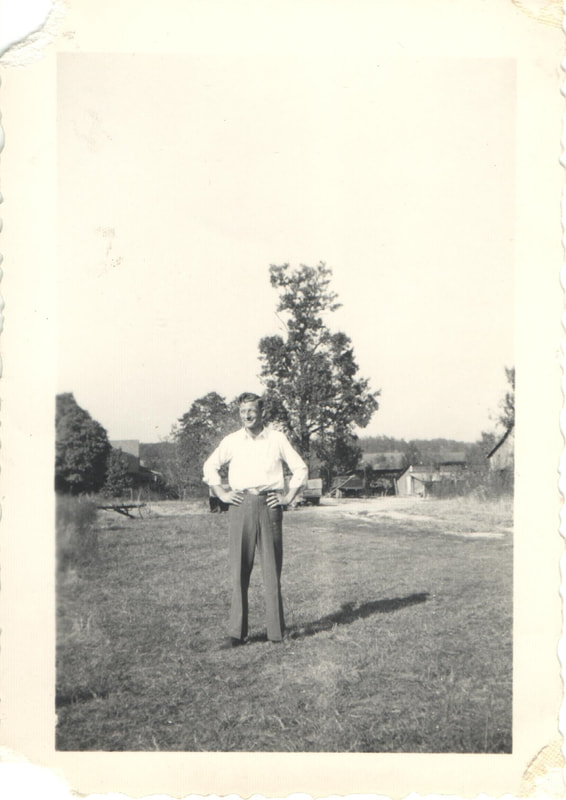 Man standing outdoors with hands on hips