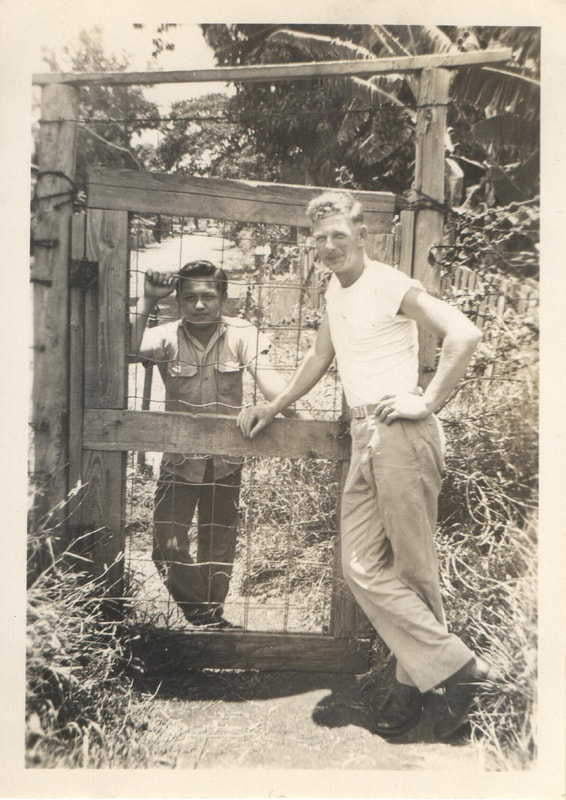 Men standing next to fence
