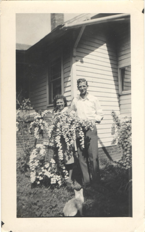 Man and woman standing in back yard garden